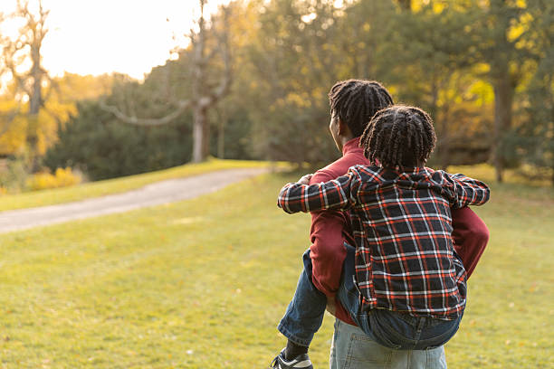 istock Black brothers having fun in the park 2245271620