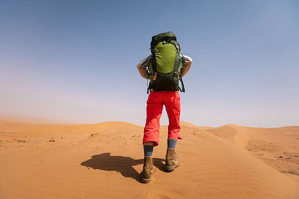 istock Woman backpacking in the desert 2245271839