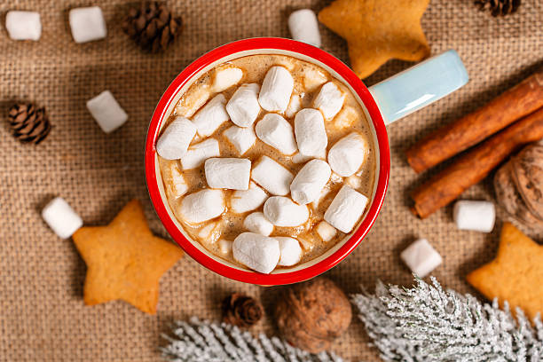 istock Mug with cocoa and marshmallows, cozy Christmas drink in a festive setting on an isolated background, top view 2245272909