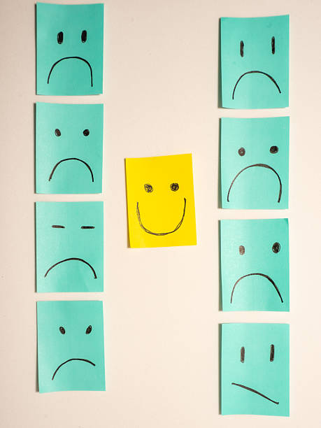 istock Sticky notes with unhappy smiley's and one happy smiley. 2245273150