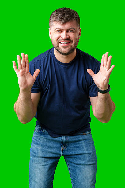 istock A surprised man expresses shock against a bright green background 2245276520