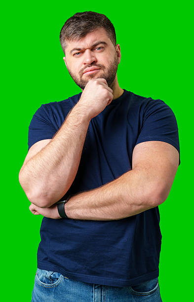 istock A man thoughtfully ponders on a bright green background 2245277005