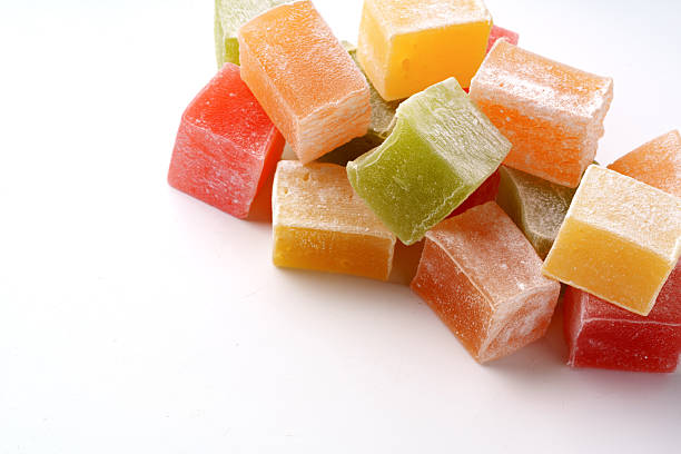 istock Colorful fruit-flavored candies arranged on a white surface creating a vibrant display of sweets and treats 2245277846