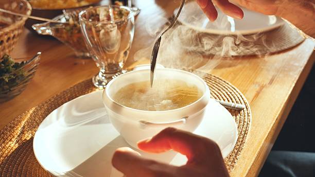 istock A man stirs the hot soup. 2245278345