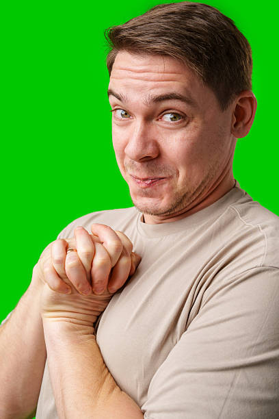 istock A cheerful man with a friendly smile poses against a bright green background 2245278754