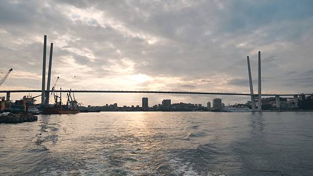 istock Vladivotok bridge. View from the moving ferry at sunset. 2245278829