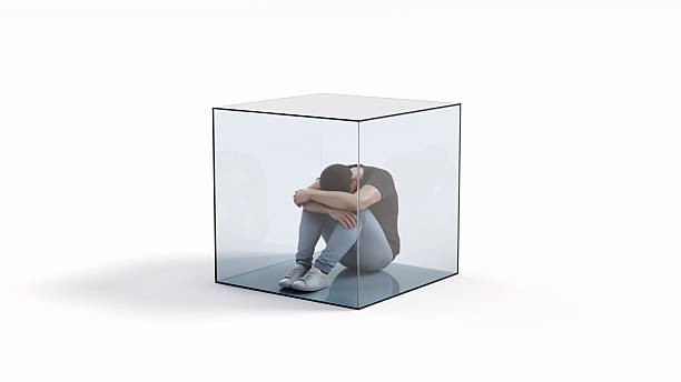 istock Man sitting trapped inside a transparent glass cube, concept of isolation, depression, mental pressure, loneliness and emotional confinement, 3d render 2245280614