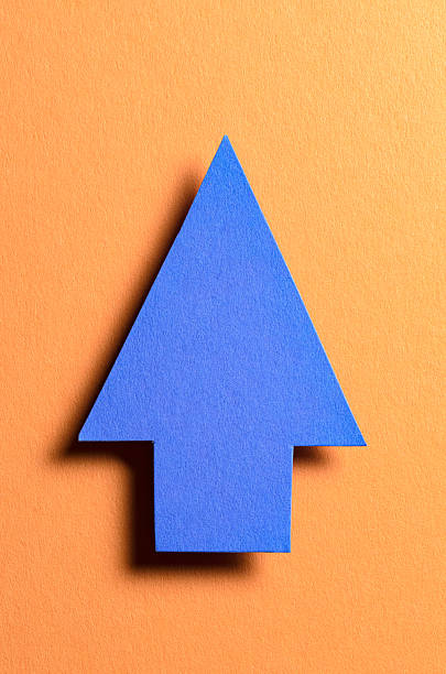 istock Blue cut out blank paper cardboard arrow direction sign with copy space for text on orange background, flat lay top view pointing symbol backdrop 2245281789