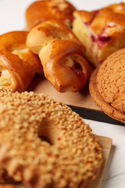 Delicious assortment of fresh baked goods displayed on a wooden board at a cozy breakfast setting