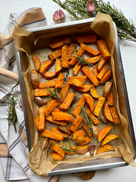 istock Baked sweet potatoes with rosemary. 2245283964
