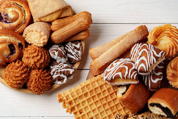 Assorted pastries and baked goods displayed on a wooden surface for a delightful dessert spread
