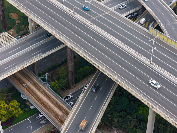istock Aerial View of Traffic on an Urban Overpass Intersection with Multiple Elevated Roads and Vehicles in Motion 2245286182