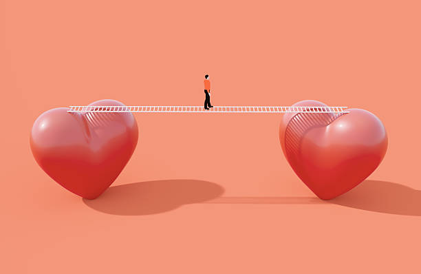 A person walking on a white bridge ladder between two heart objects on orange background. Love harmony and relationship difficulties concept.