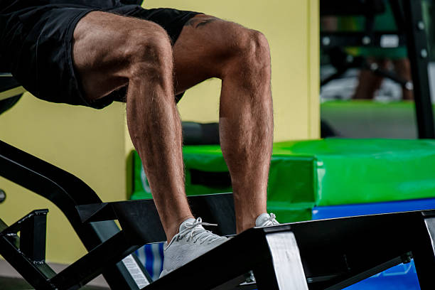 istock Male Athlete Training on Leg Machine at Gym 2245290758