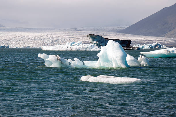 Jokulsarlon is the largest and most active glacial lake in Iceland. It provides outstanding views of the ice cap Vatnajokull, a vast dome of ice that rises to a height of 900 m (3,000 ft) and shows how the outlet glacier Breidamerkurjokull calves into the lagoon.  Icebergs gather at the mouth of the lake's shallow exit, melt down into smaller ice blocks, and roll out into the sea.