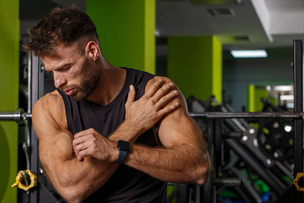 istock Athlete experiencing shoulder pain after weightlifting, gym scene. 2245291894