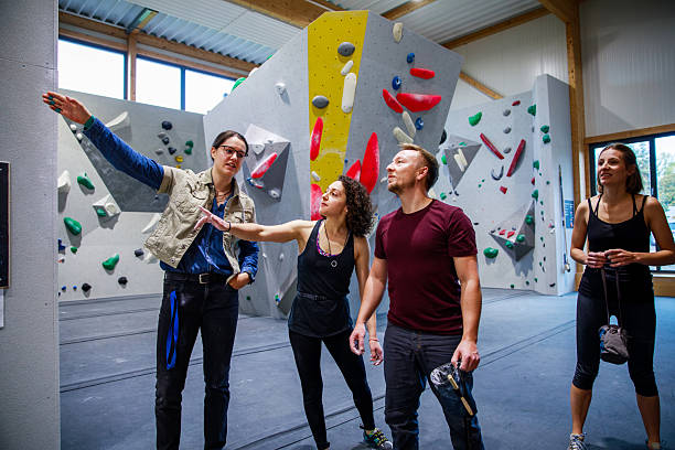 istock Team Climbing Friends Plan Route In Indoor Gym 2245292038