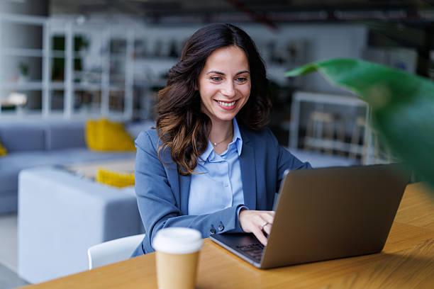 istock Businesswoman working remotely on laptop with coffee 2245292584