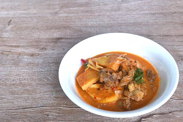 istock spicy boiled slice fresh bamboo shoot with beef meat topping in coconut milk curry soup 2245292829