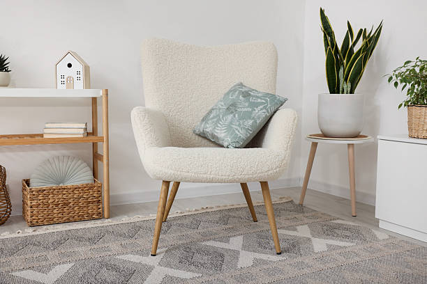 istock Stylish armchair, console table and different decor in room. Interior design 2245295558