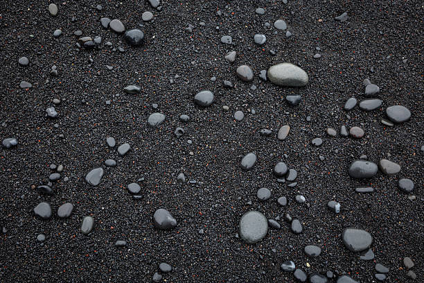Black sand and pebbles in Reynisfjara, the Black Sand Beach in southern Iceland