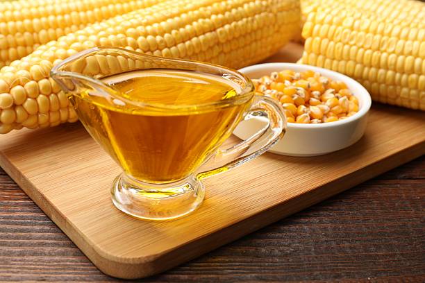 istock Corn oil, kernels and cobs on wooden table, closeup 2245298478