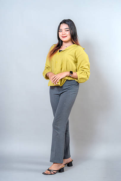 istock Young Asian woman with a confident and friendly facial expression, smiling slightly while standing in a relaxed pose. Perfect for lifestyle, fashion, and advertising visual content. 2245299006