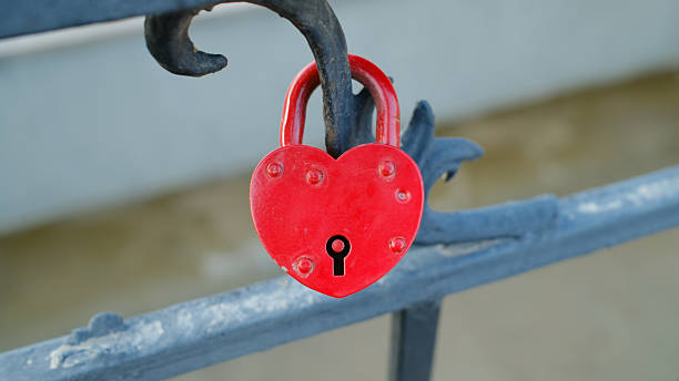 istock Red heart-shaped love lock on metal railing symbolizing affection and romance 2245299472