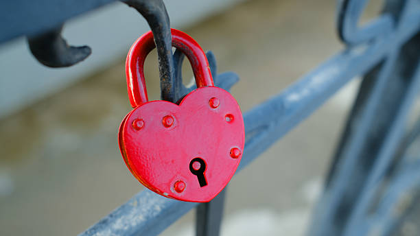 istock Red heart-shaped love lock on metal railing symbolizing affection and romance 2245299752