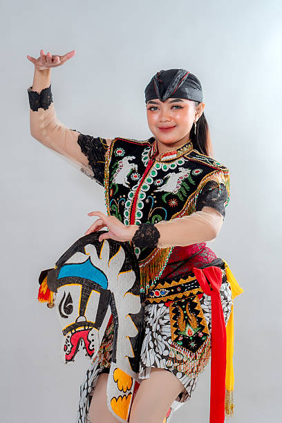 istock A female Javanese dancer in vibrant traditional costume performs the Jathilan dance, holding a painted flat horse puppet symbolizing cultural pride and mystical Indonesian heritage. 2245299877