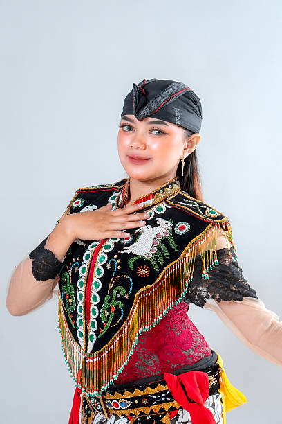 istock Javanese Jathilan dancer in vibrant traditional attire performs a graceful pose, showcasing Indonesia's rich cultural heritage through detailed costume, colors, and expressive elegance. 2245300034