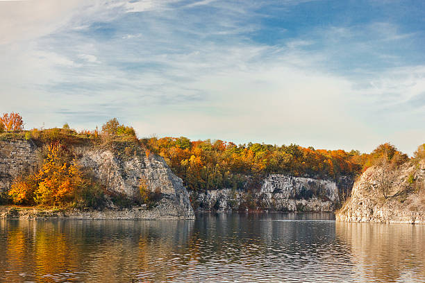 istock lake with steep banks and yellow trees 2245300462