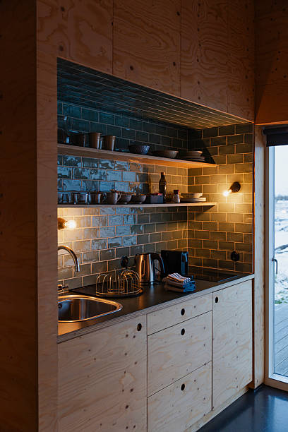 istock Compact kitchen with wood cabinets, shelves, and tile backsplash design. 2245300848