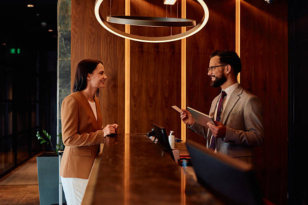 istock Woman checking in hotel reception with concierge 2245302695