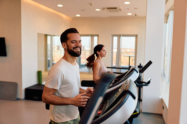 istock People running on treadmills during gym workout 2245302781