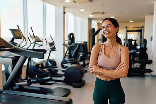 istock Happy woman smiling standing in modern gym 2245303170