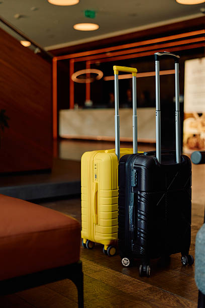 istock Yellow and black luggage standing in hotel lobby 2245303465