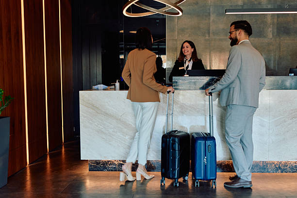 istock Couple checking in at hotel reception desk 2245303518