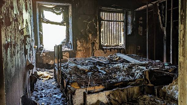 istock Fire damaged bedroom, arson aftermath. Melted bed, twisted metal, bare springs. Charred room walls. Scene of destruction, danger, death and disaster. Evidence of blaze, burnt remains. Incinerated wreckage after criminal vandalism ravaged home after attack 2245303620