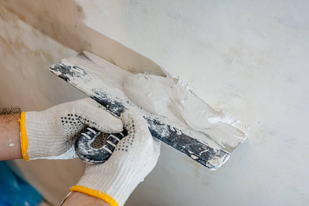 istock Detailed process shot of a professional plasterer applying material with a trowel, a key step in modern construction and building. 2245303681