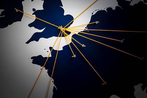 Connection concept: The UK, specifically London, connecting with major cities in the European Union - illustrated by yellow-coloured wool tied to nails. The yellow and blue colours are indicative of the EU flag.