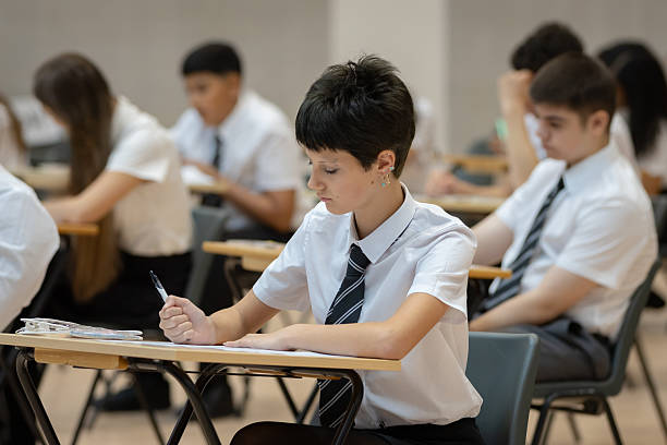istock High school student sitting an exam in a large hall 2245310400