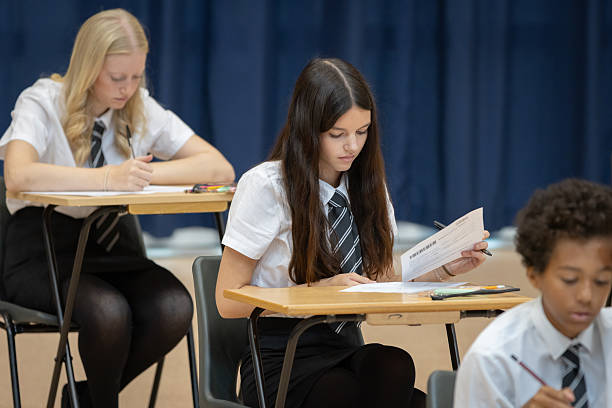 istock High school student reading exam papers in a large hall 2245310476
