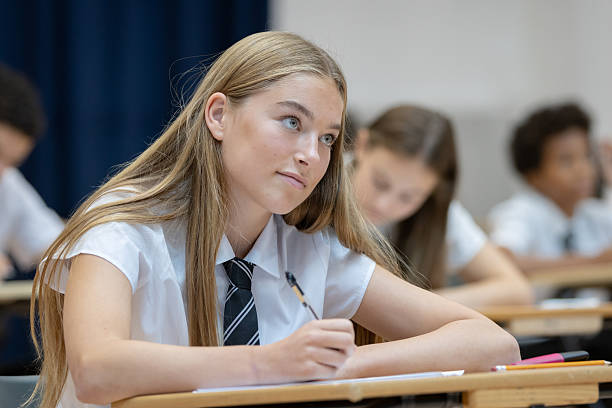 istock Confident high school student sitting an exam in a large hall 2245311422