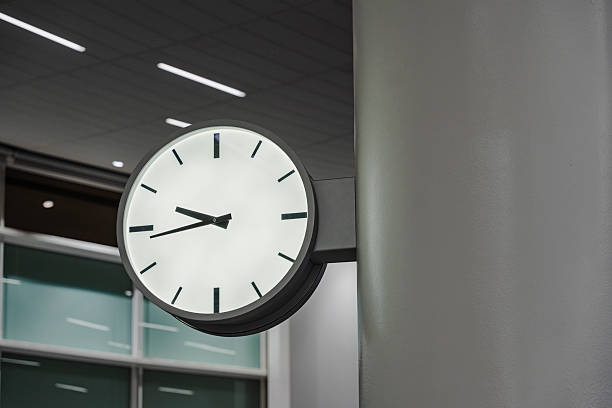 istock Wall-mounted clock showing the time. Minimalist clock design in an interior space. Time is of the essence. 2245311845