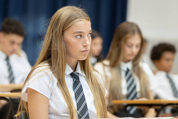 istock High school students in school hall, waiting for an exam to begin 2245312186