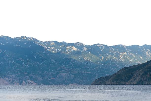 Serene mountain range reflected in calm lake. Isolated object on white background.
