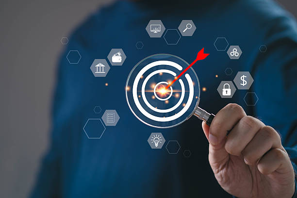 istock Businessman using magnifying glass to aim at digital target with red arrow, representing business strategy, goal setting, success planning, and digital marketing precision. 2245315799