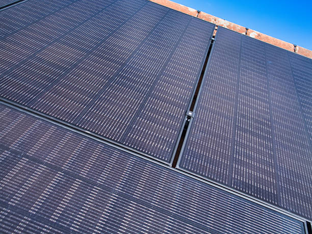 istock Residential Solar Panels on Roof Under Clear Blue Sky 2245317581