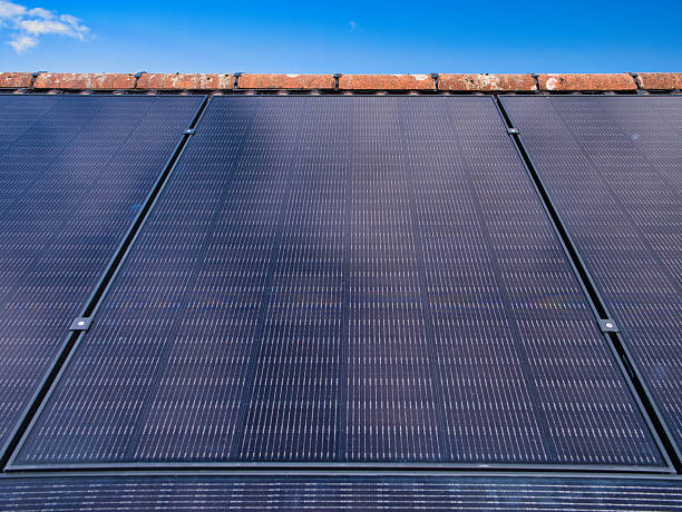 istock Residential Solar Panels on Roof Under Blue Sky 2245317583